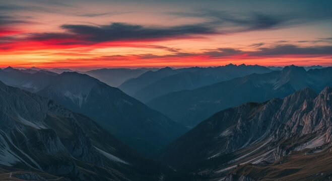 Breathtaking panoramic view of a dramatic sunset over a majestic mountain range