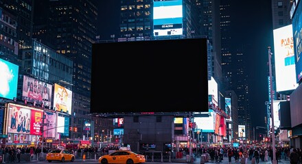 Nighttime view of Times Square in New York City with illuminated billboards and taxis