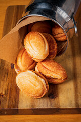 Delightful golden cookies rest on a wooden surface, creating a warm and inviting feel