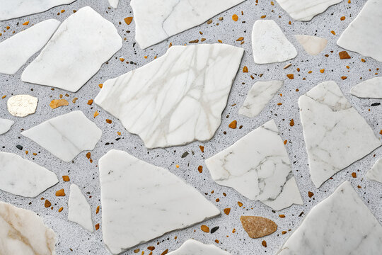 Luxury terrazzo texture with large Carrara marble pieces and amber-gold aggregate in a polished gray composite surface for interior design generative ai - Powered by Adobe