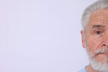 Senior man on light background. Space for text