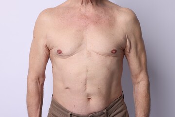 Fototapeta premium Shirtless senior man on light background, closeup