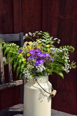A bouquet of wild flowers in a milk can for Midsummer at the old red house.