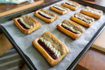Puff pastry tarts with cream cheese, cherry jam, peanut butter. Dessert. pastry