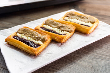 Puff pastry tarts with cream cheese, cherry jam, peanut butter. Dessert. pastry