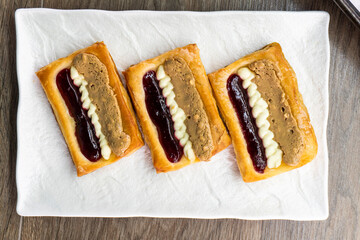 Puff pastry tarts with cream cheese, cherry jam, peanut butter. Dessert. pastry