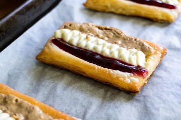 Puff pastry tarts with cream cheese, cherry jam, peanut butter. Dessert. pastry