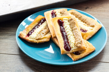Puff pastry tarts with cream cheese, cherry jam, peanut butter. Dessert. pastry