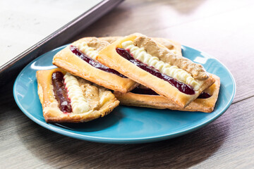 Puff pastry tarts with cream cheese, cherry jam, peanut butter. Dessert. pastry