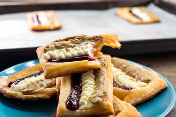 Puff pastry tarts with cream cheese, cherry jam, peanut butter. Dessert. pastry