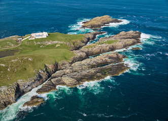 aerial view of the Iighthouse on the rocky cliffs  of Strathy point in northern Scotland , UK