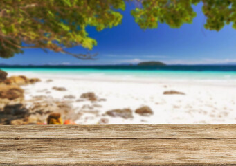 Wooden table top on the beach or sea.Party on the beach  sunshine time concept.For montage product display or design key visual layout.View of copy space.