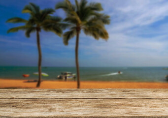 Wooden table top on the beach or sea and coconuttrees .Party on the beach  daytime concept.For montage product display or design key visual layout.View of copy space.