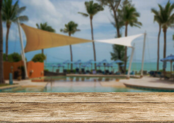 Wooden table top on the beach or sea. swimming pool Party on the beach  sunshine time concept.For montage product display or design key visual layout.View of copy space.