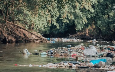 A lot of garbage and plastics in the river, Polluted and dirty river, Water pollution