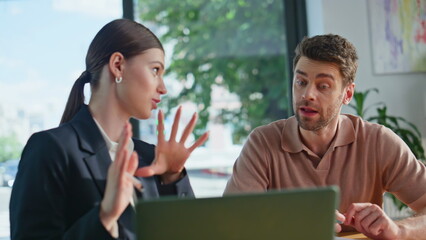 Business partners discussing project at laptop sitting corporate office closeup.