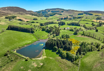 agricultural landscape with meadows and pastures at the border of the Cairn Gorm National Park in Scotland, UK