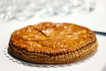 Galette des Rois (French King Cake) with Feve and Crown usually shared on the Epiphany to celebrate the arrival of the Three Wise men in Bethlehem.