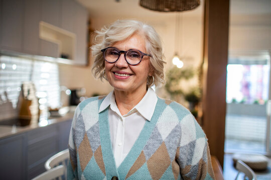 Happy senior woman smiling confidently at home