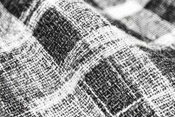 Obraz premium Close-up of textured black and white fabric. Woven pattern, detailed weave visible