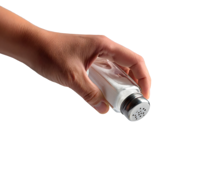 Hand sprinkling salt from a shaker.
