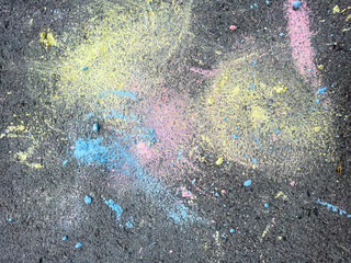 Doodles drawn on asphalt by children with colored chalks