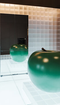 Green apple in front of mirror refrigerator
