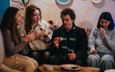 A group of friends shares snacks and lively conversation in a warm, inviting atmosphere.