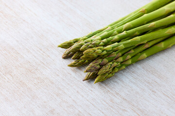 Fresh Green Asparagus on White Wooden Background