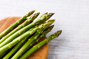 Fresh Green Asparagus on White Wooden Background