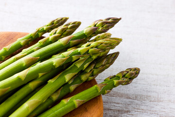 Fresh Green Asparagus on White Wooden Background
