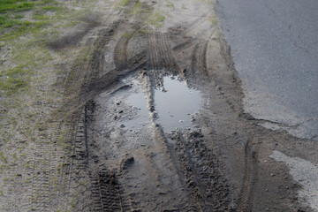 Dirty Mud Road with Water with Car Track
