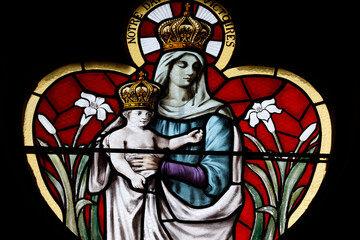 Saint Marien church.  Stained glass. The crowned Virgin Mary carrying the baby Jesus in her arms.  ...
