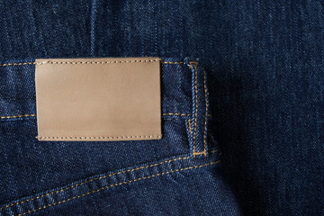 Tag or label on fabric jeans for shopping, sale and discount information. Blank template for branding and product presentation top view.