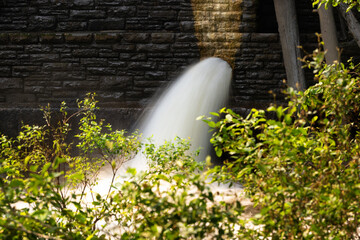Water pouring out a dam spillway