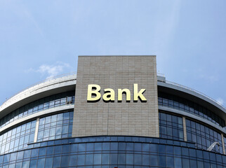 Volumetric inscription Bank on the glass wall of the building