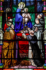 Obraz premium Saint Pierre church. Stained glass. Saint Dominic receiving the Rosary from the Virgin. Toucy. France.