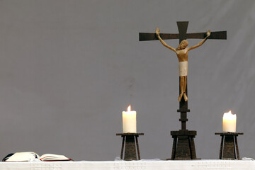 Saint Pierre church.  Jesus on the cross. The crucifixion. Altar with two church candles. Toucy. ...