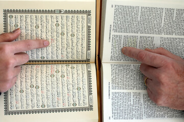 Naklejka premium Two monotheistic religions. A Christian and a Muslim reading the Bible and the Quran. Islam and christianity. Symbol of peace and interfaith dialogue.