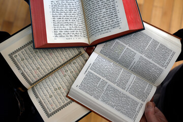 Three monotheistic religions. A Christian, a Jew, and a Muslim reading the Bible, the Torah, and...