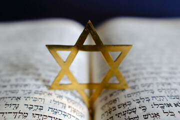 Fototapeta premium Judaism. The Bible in Hebrew with a star of David.
