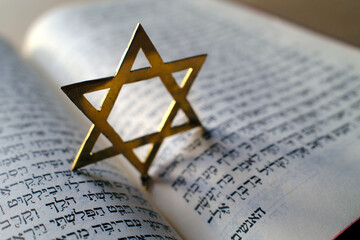 Fototapeta premium Judaism. The Bible in Hebrew with a star of David.