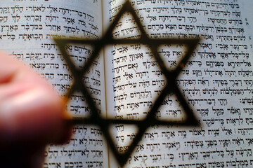 Fototapeta premium Judaism. The Bible in Hebrew with a star of David.