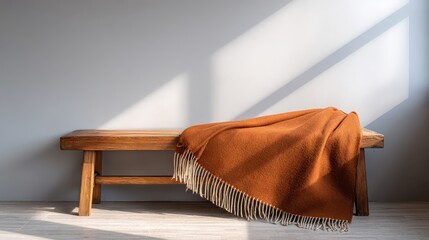Cozy Brown Blanket Draped Over Wooden Bench in Minimalist Space