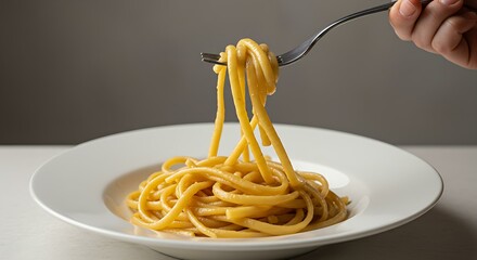 Pasta being twirled on a fork over a white plate