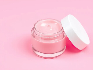 Glass jar of pink cream with white lid on pastel pink background, evoking soft and elegant aesthetic