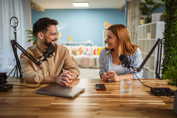 man and woman host and guest in podcast at home studio