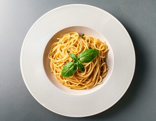 overhead view of a plate of spaghetti with basil