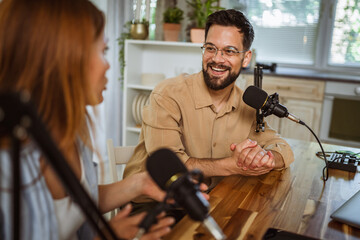 man and woman host and guest in podcast at home studio