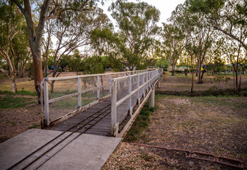 Fototapeta premium Narrow Railing on a Pedestrian Bridge Over Bungil Creek in Natural Park Setting, Roma, Australia, 28 November 2020